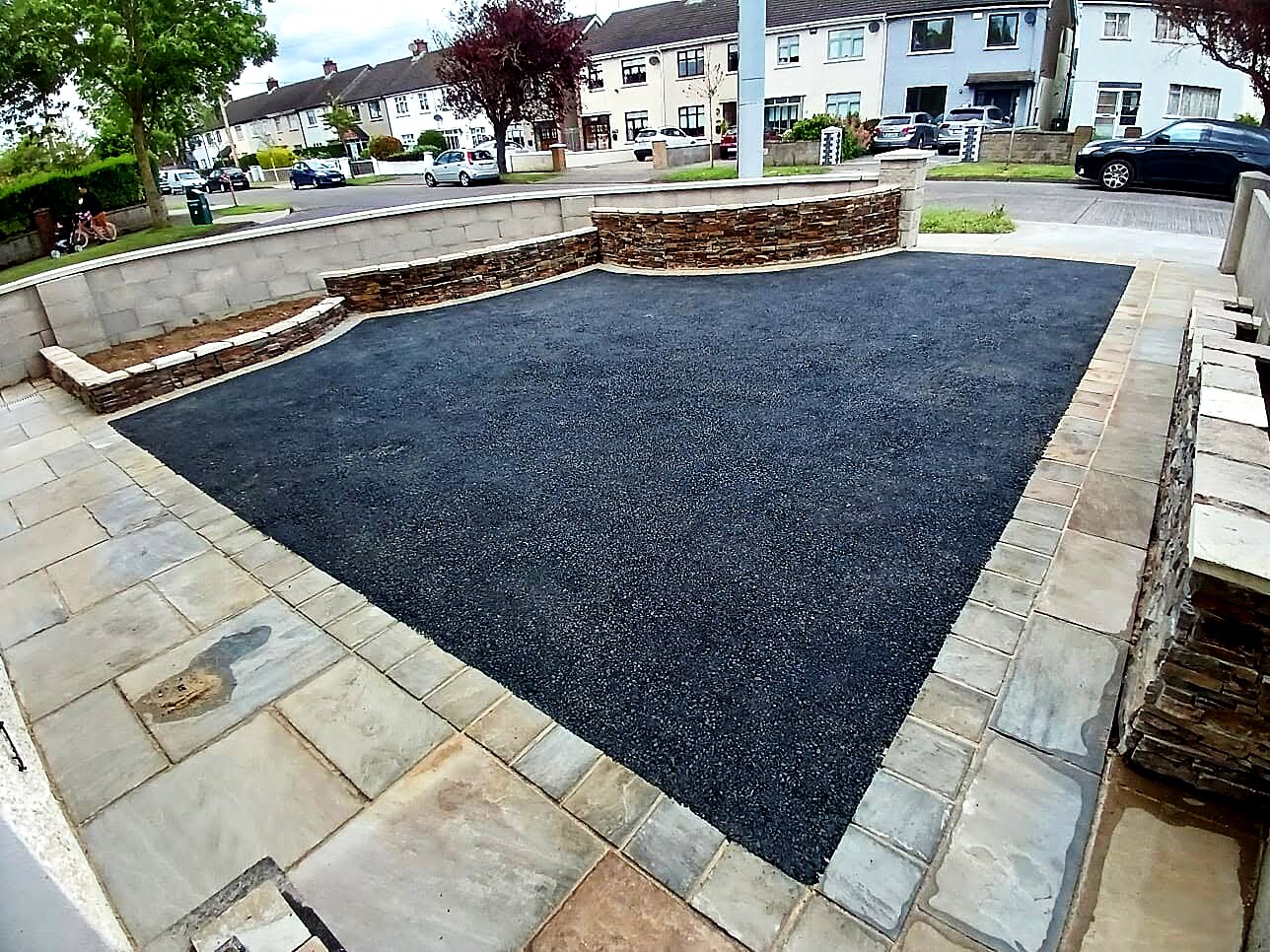 Completed Topline driveway with a clean tarmac surface and natural sandstone borders
